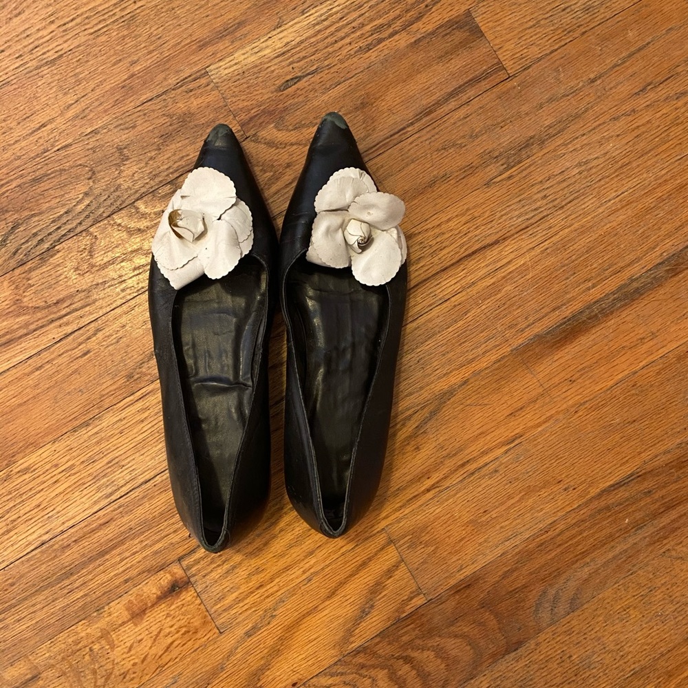 Black leather flats with flower embellishment